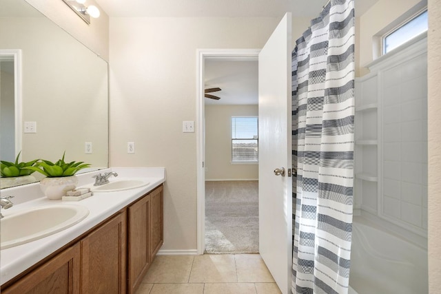 bathroom featuring double vanity, a shower with shower curtain, tile patterned flooring, and a sink