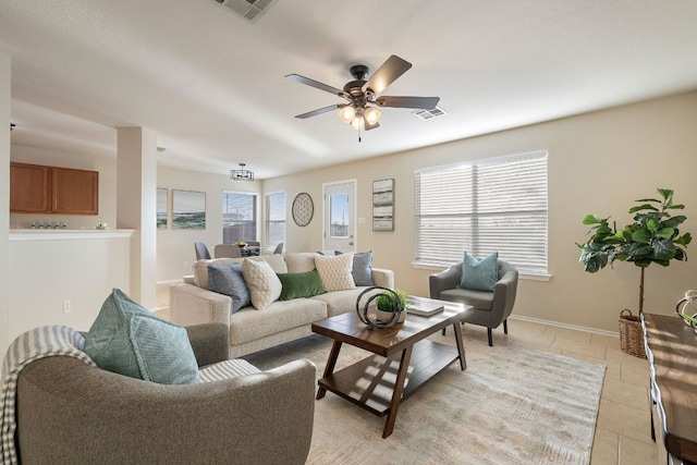 living area featuring visible vents, a wealth of natural light, and light tile patterned flooring