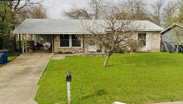 ranch-style home featuring stone siding, a front lawn, and an attached carport