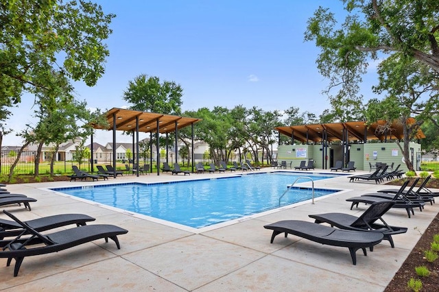 community pool with fence and a patio