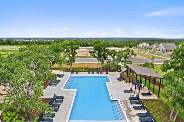 community pool featuring a patio and fence