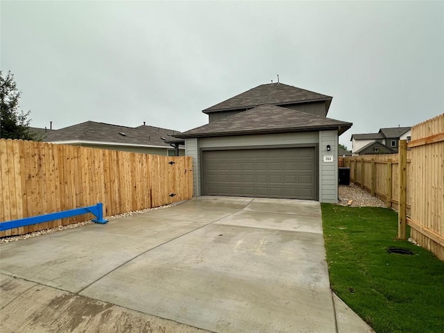 view of side of property with roof with shingles