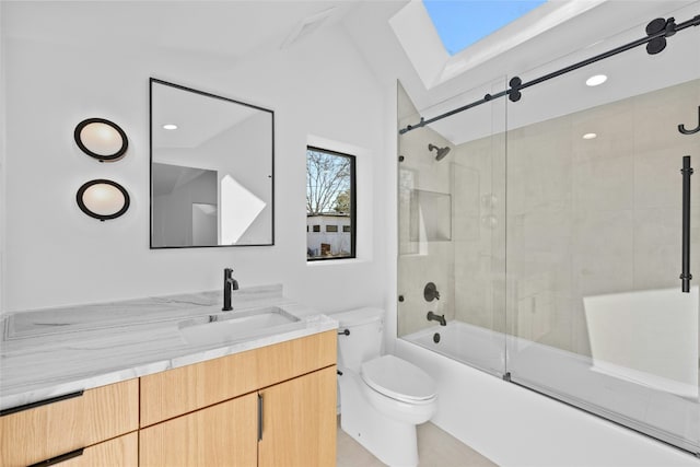 full bathroom with combined bath / shower with glass door, a skylight, vanity, and toilet