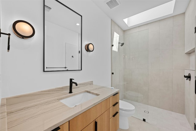 bathroom with toilet, a skylight, visible vents, and a walk in shower