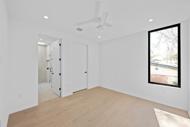 unfurnished room featuring baseboards, visible vents, a ceiling fan, light wood-style floors, and recessed lighting