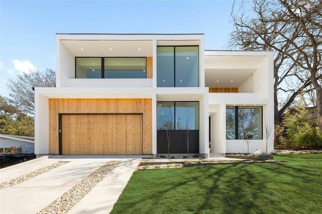 modern home featuring stucco siding, concrete driveway, an attached garage, a balcony, and a front lawn