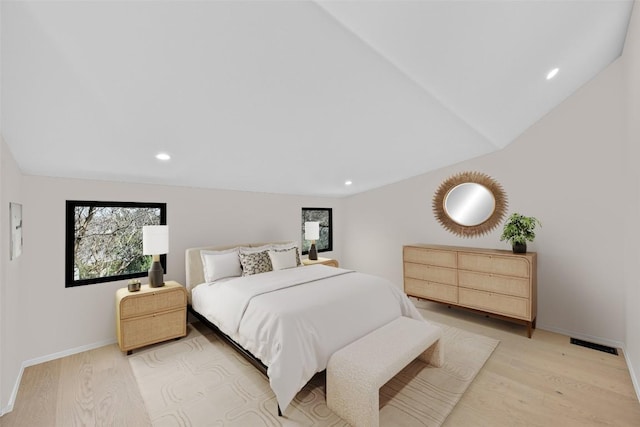 bedroom with visible vents, light wood-style flooring, and baseboards