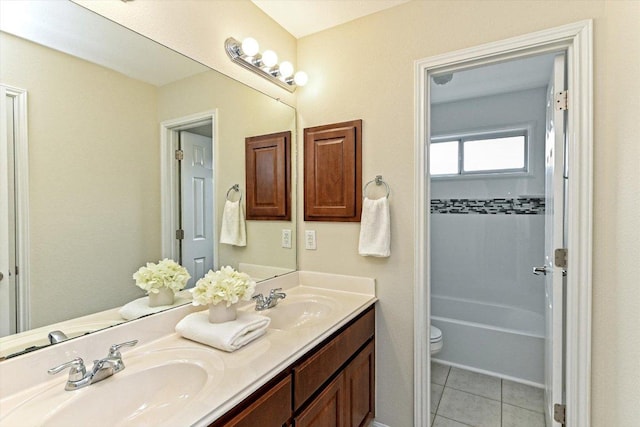 full bath with double vanity, tile patterned flooring, a sink, and toilet