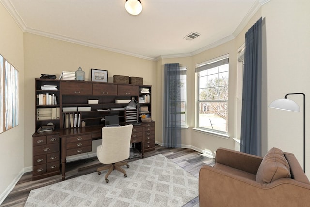 office space featuring ornamental molding, visible vents, baseboards, and wood finished floors