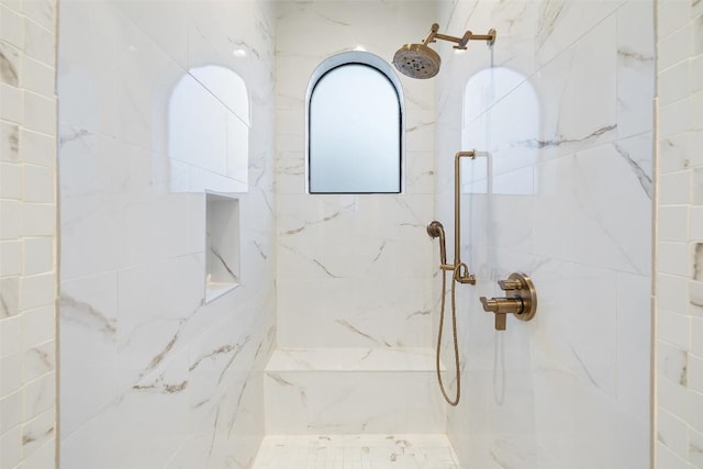 bathroom with a marble finish shower