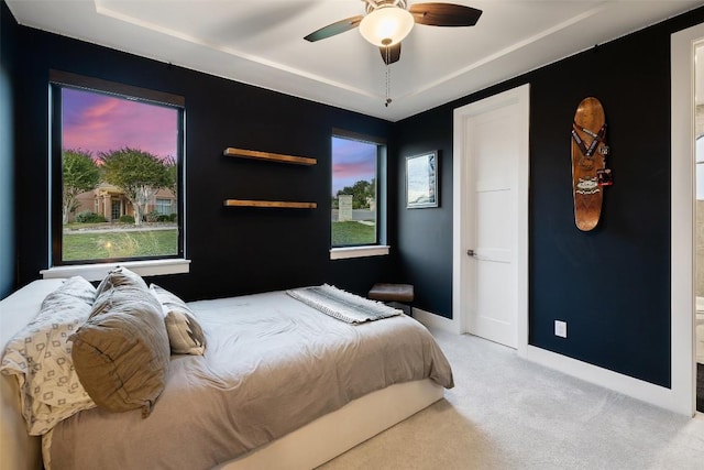 carpeted bedroom featuring a ceiling fan and baseboards