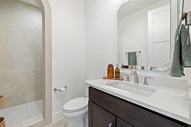 bathroom with vanity, toilet, and a walk in shower