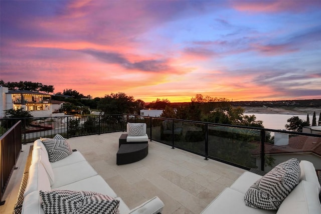 view of patio featuring a water view, a balcony, and an outdoor hangout area