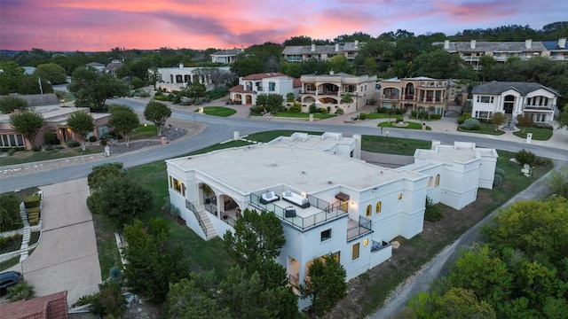 aerial view at dusk featuring a residential view