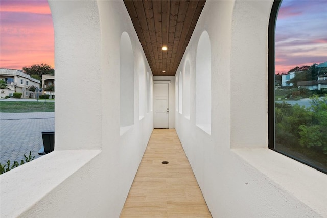 hall featuring wood ceiling and wood finished floors