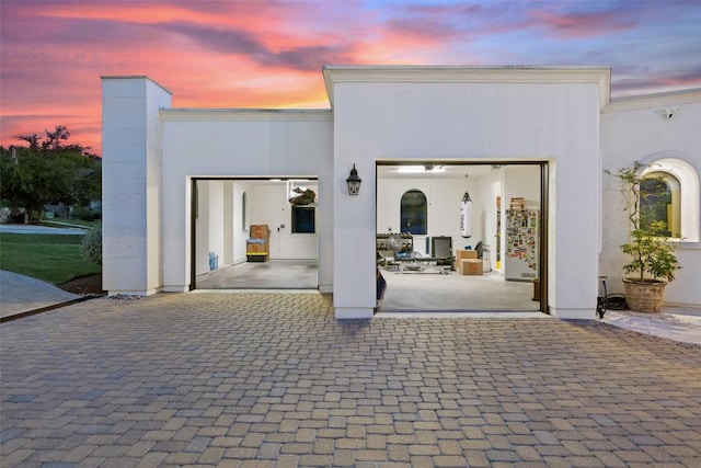 view of patio / terrace featuring decorative driveway and an attached garage