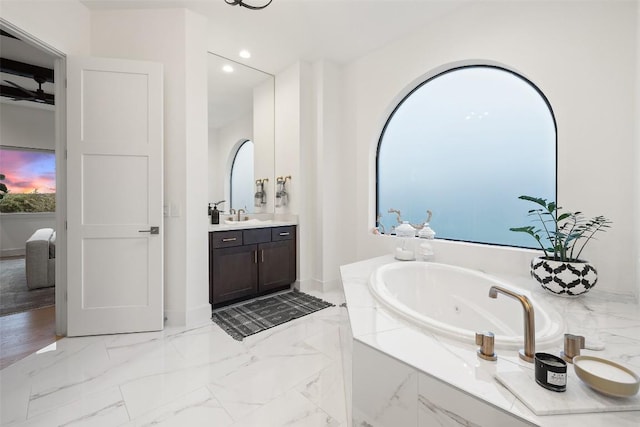 bathroom with marble finish floor, recessed lighting, connected bathroom, vanity, and a jetted tub