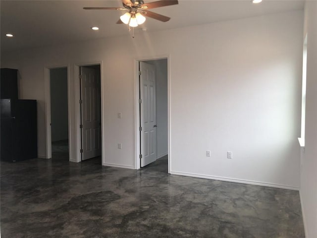 spare room featuring concrete floors, baseboards, a ceiling fan, and recessed lighting