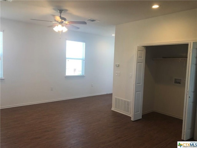 interior space featuring dark wood-style floors, visible vents, and baseboards
