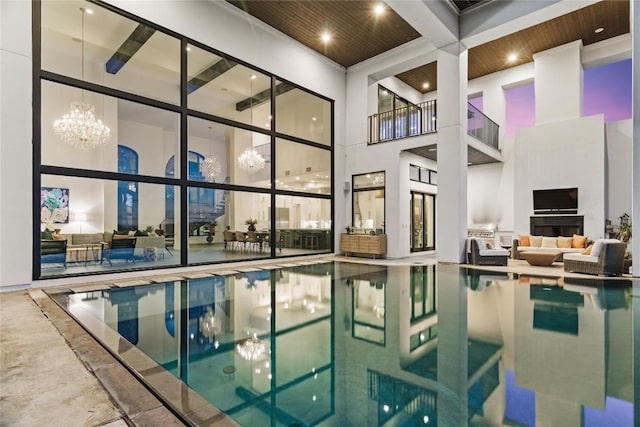 indoor pool featuring a fireplace