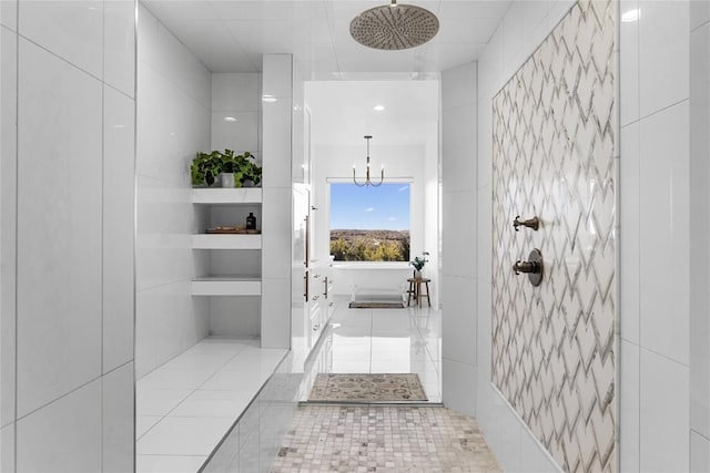 full bath with a chandelier, tiled shower, tile patterned flooring, and tile walls