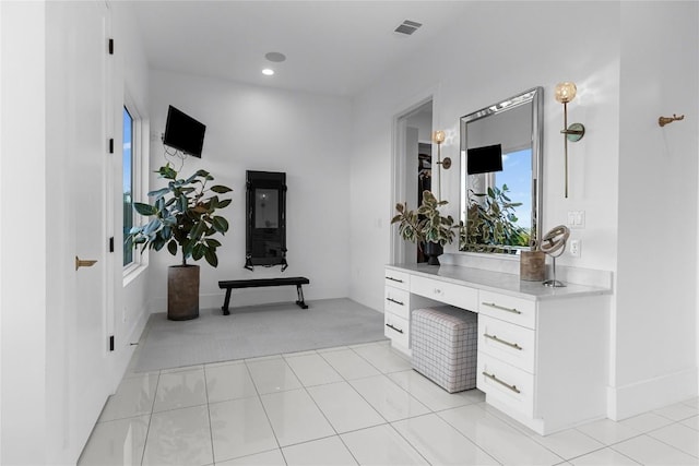 hall featuring recessed lighting, visible vents, baseboards, and light tile patterned floors