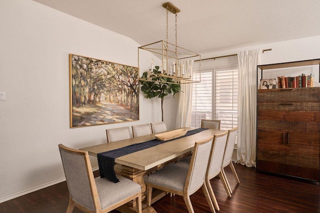 dining space featuring dark wood-style flooring and baseboards