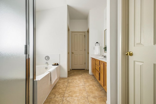 full bath featuring tile patterned floors, a shower stall, a garden tub, and vanity
