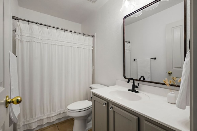 full bathroom with vanity, toilet, and tile patterned flooring