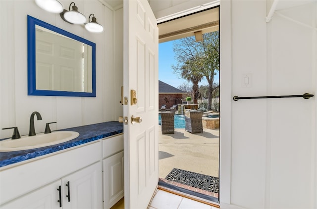 bathroom featuring vanity and a decorative wall