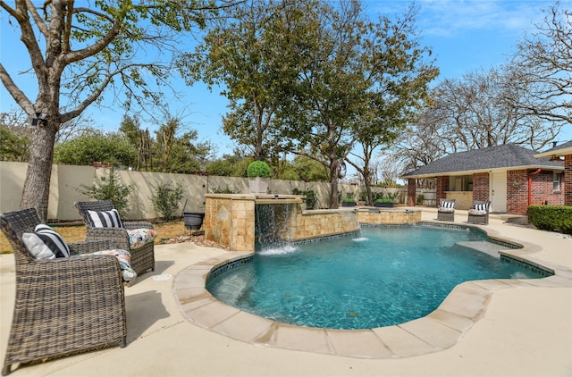 view of swimming pool featuring exterior kitchen, a fenced backyard, an outdoor structure, and a patio