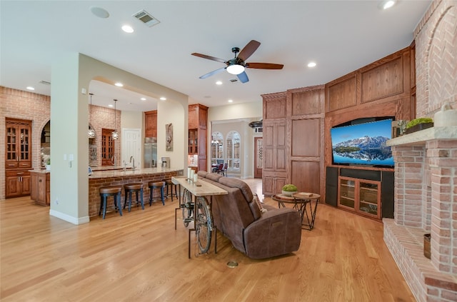 interior space with visible vents, brick wall, ceiling fan, light wood-style floors, and recessed lighting