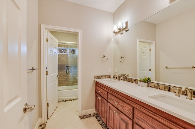 bathroom with tile patterned flooring, enclosed tub / shower combo, a sink, and double vanity