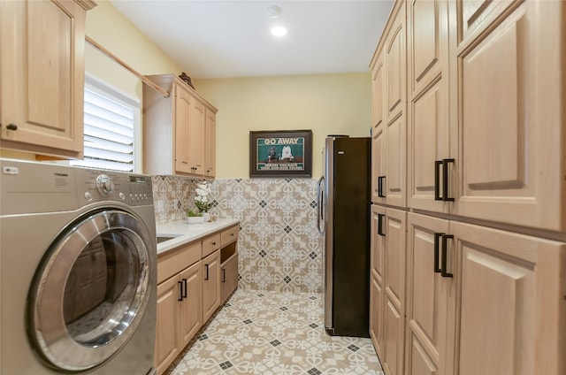 washroom with a wainscoted wall, washer / clothes dryer, cabinet space, and tile walls