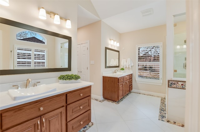 bathroom featuring two vanities, a sink, visible vents, and tile patterned floors