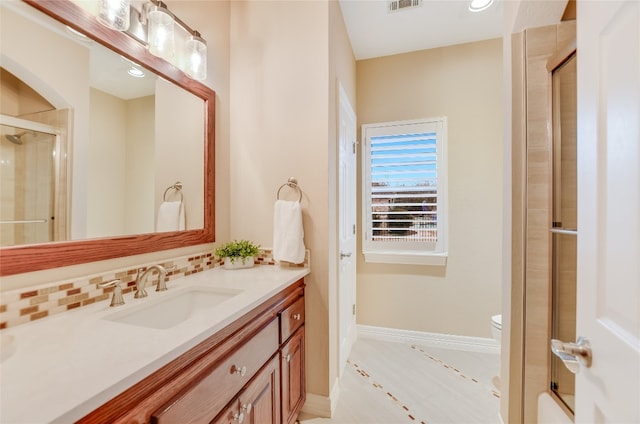 bathroom with tasteful backsplash, visible vents, baseboards, a shower with door, and vanity