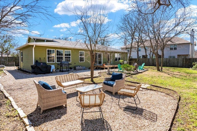 rear view of house with outdoor lounge area, a lawn, a patio area, and fence