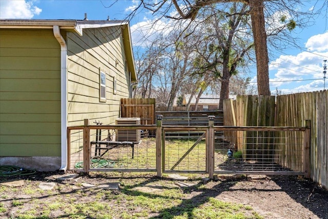 view of yard with fence and a gate