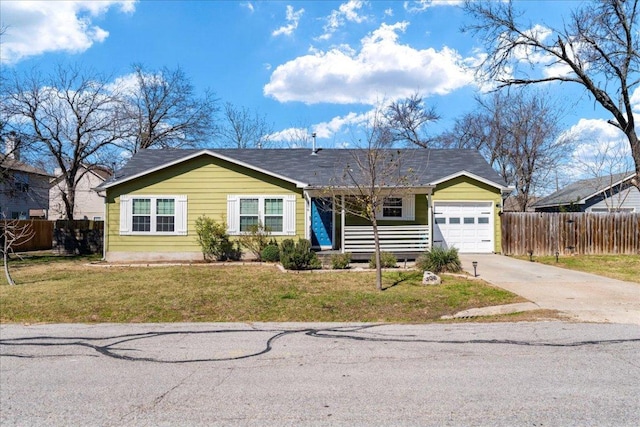 ranch-style home featuring a garage, fence, driveway, and a front lawn