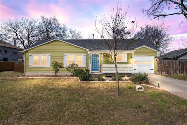 ranch-style house with concrete driveway, fence, an attached garage, and a lawn