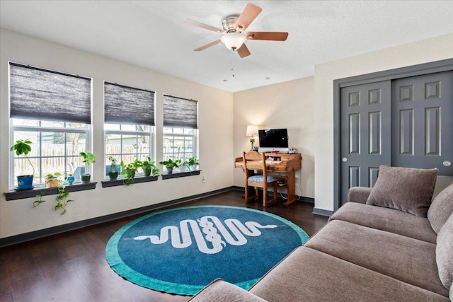 living room featuring ceiling fan, wood finished floors, and baseboards