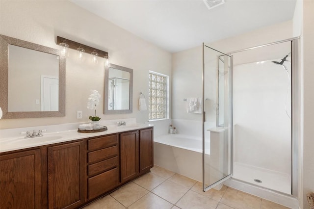 full bathroom featuring a sink, a shower stall, a bath, and tile patterned floors