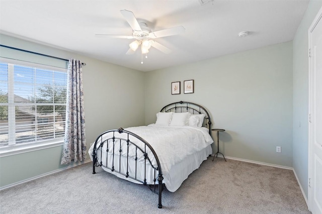 bedroom with carpet, a ceiling fan, and baseboards