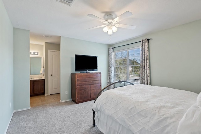 bedroom featuring visible vents, a ceiling fan, light carpet, connected bathroom, and baseboards