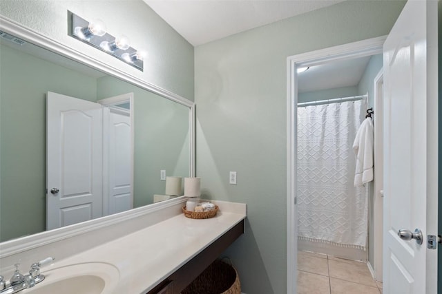 full bath with a shower with curtain, vanity, visible vents, and tile patterned floors