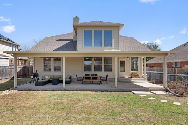 rear view of property featuring a yard, a patio, an outdoor hangout area, ceiling fan, and fence