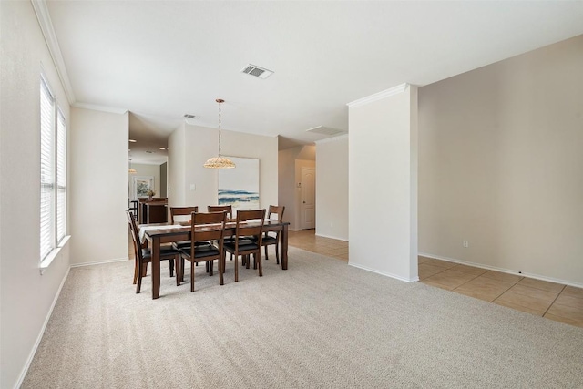 dining space with crown molding, light tile patterned floors, light colored carpet, visible vents, and baseboards