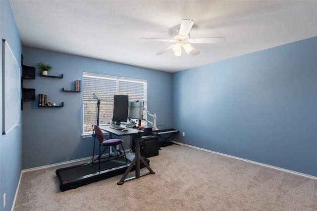 carpeted home office featuring ceiling fan and baseboards