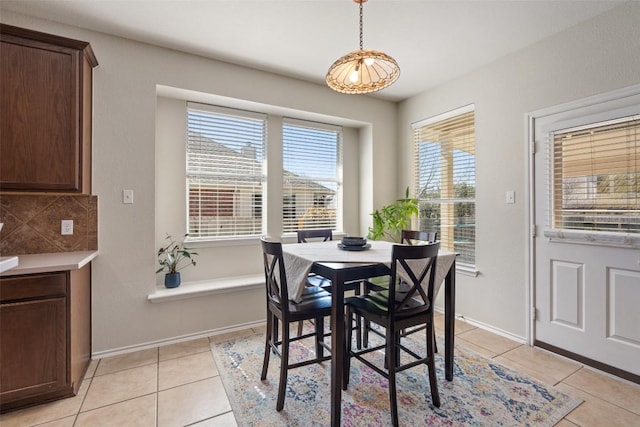 dining room with light tile patterned floors and baseboards