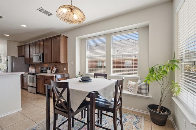 dining area featuring light tile patterned floors, baseboards, visible vents, and recessed lighting